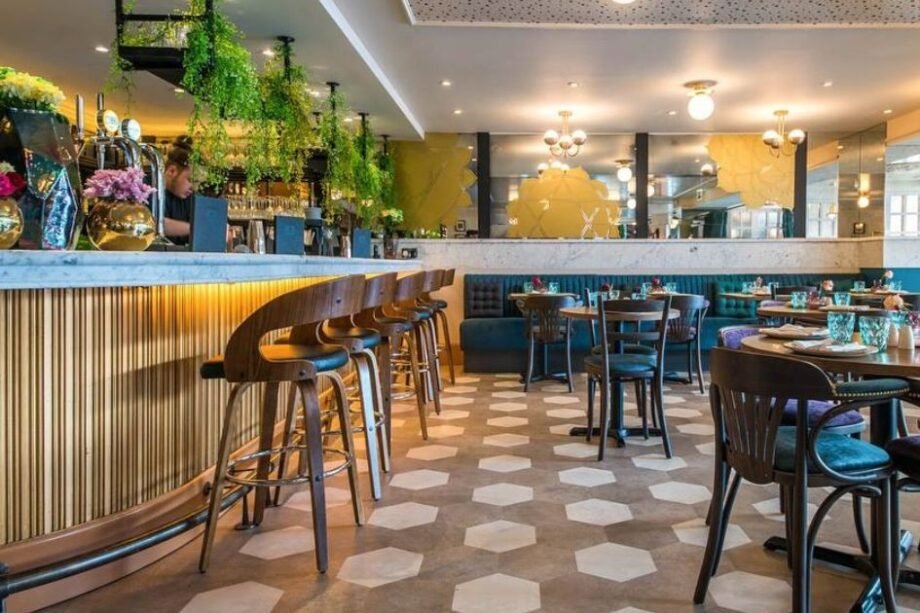 Image of tables and chairs and barman at Chakra restaurant