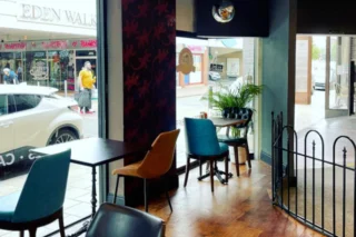 An image of an interior inside Apia Cafe with tables and chairs