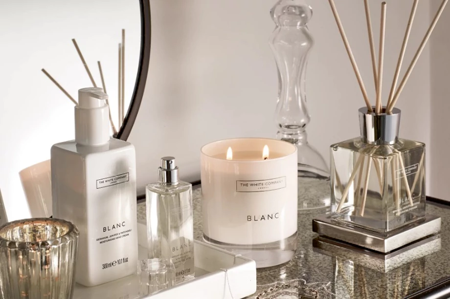 A picture of candles and diffusers in front of a mirror