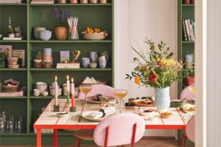 A modern Nordic-style dining room with a set table.